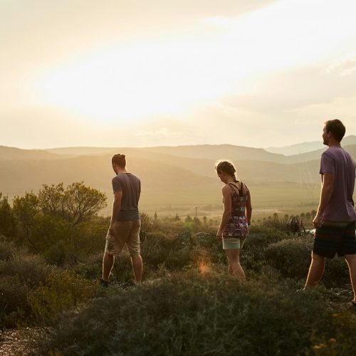 Life is better in hiking boots. Rearview shot of three young hikers on a mountain trail.